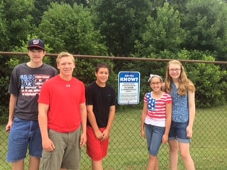 The Thomas family, posting warning signs at their pool club
